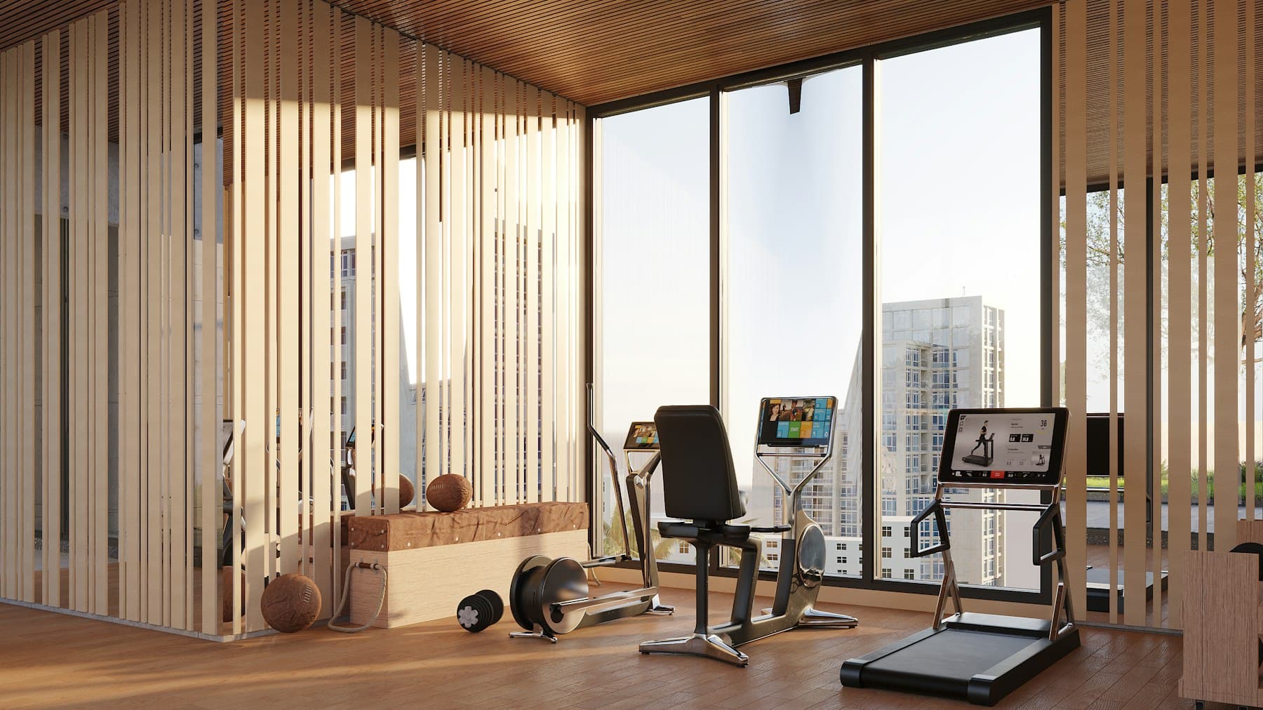 Gimnasio en un apartamento con trotadora, banco y vista a la ciudad